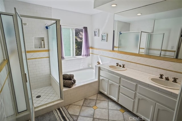 bathroom with a shower stall, tile patterned flooring, a garden tub, double vanity, and recessed lighting