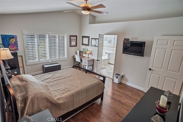 bedroom with lofted ceiling, baseboards, wood finished floors, ensuite bath, and ceiling fan