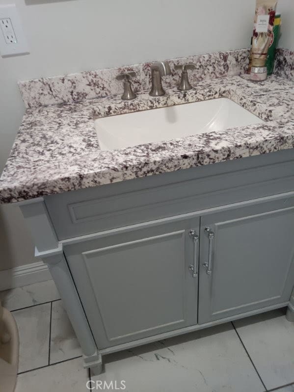 2506 E 130th St, Compton, CA 90222 - bathroom featuring marble look tiles and vanity