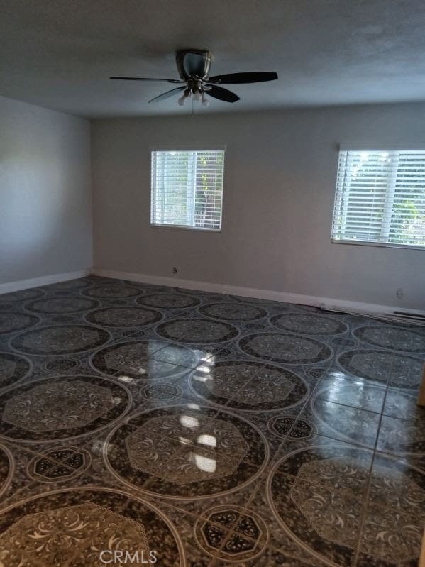 2506 E 130th St, Compton, CA 90222 - spare room with healthy amount of natural light, ceiling fan, and baseboards
