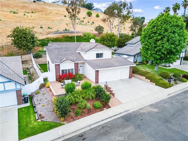 28705 Charreadas, Laguna Niguel, CA 92677 - view of front of home featuring driveway, a tiled roof, a fenced backyard, an attached garage, and stucco siding