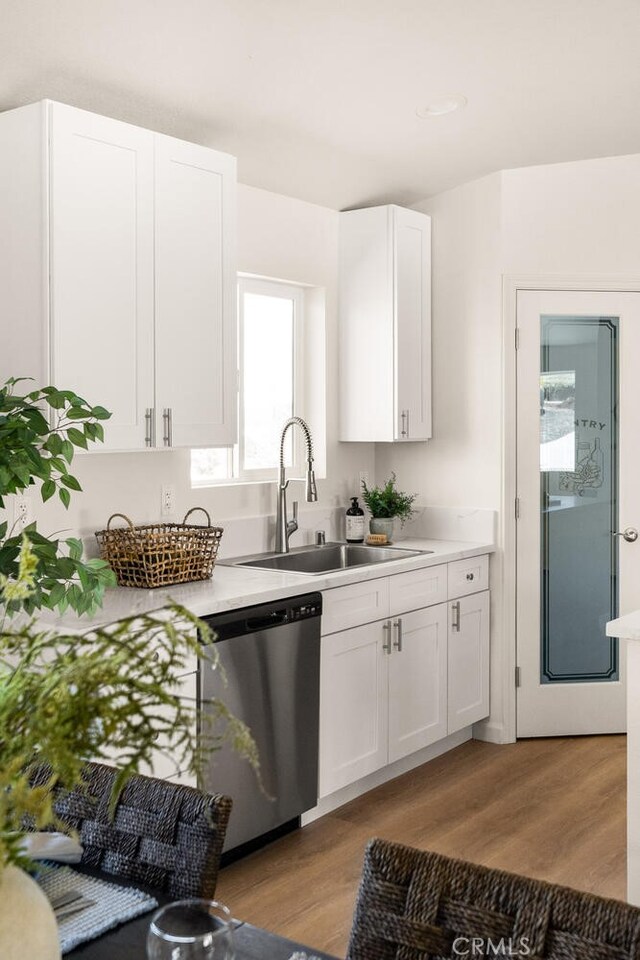 6333 Graham Rd, Paradise, CA 95969 - kitchen with stainless steel dishwasher, a sink, light wood-type flooring, and white cabinets