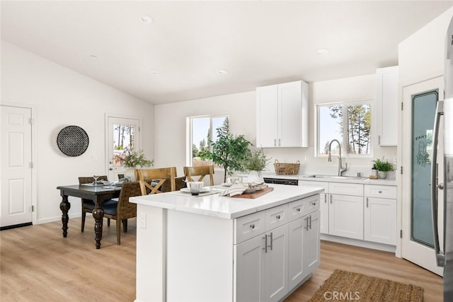 6333 Graham Rd, Paradise, CA 95969 - kitchen with a sink, white cabinetry, a center island, light wood-type flooring, and vaulted ceiling