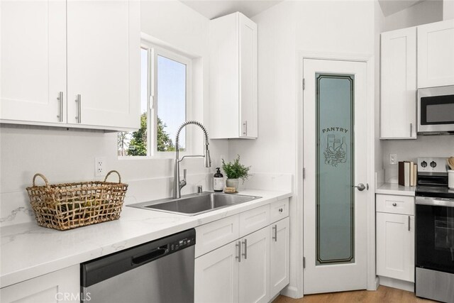 6333 Graham Rd, Paradise, CA 95969 - kitchen with appliances with stainless steel finishes, a sink, white cabinets, and light stone counters