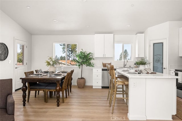 6333 Graham Rd, Paradise, CA 95969 - kitchen featuring dishwasher, light wood-style flooring, a kitchen island, white cabinetry, and light countertops