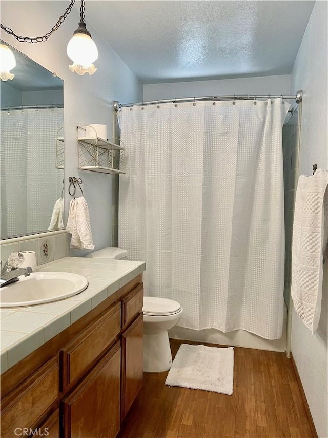 8127 Kingston Ave, Hesperia, CA 92345 - full bathroom with wood finished floors, vanity, and toilet