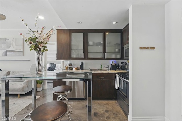 140 Linden Ave Unit 615, Long Beach, CA 90802 - kitchen featuring appliances with stainless steel finishes, dark brown cabinets, glass insert cabinets, finished concrete floors, and recessed lighting