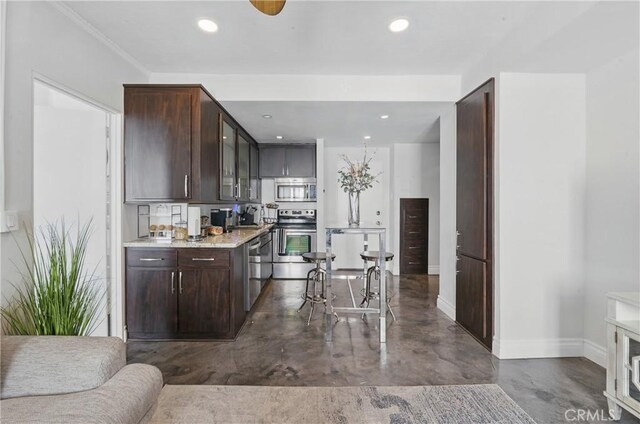 140 Linden Ave Unit 615, Long Beach, CA 90802 - kitchen with appliances with stainless steel finishes, finished concrete flooring, baseboards, dark brown cabinetry, and recessed lighting