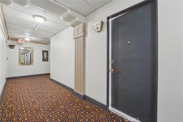 140 Linden Ave Unit 615, Long Beach, CA 90802 - corridor featuring a paneled ceiling, baseboards, and carpet flooring