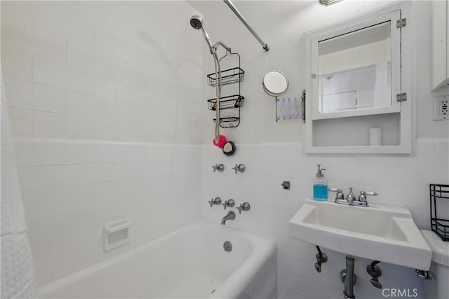 140 Linden Ave Unit 615, Long Beach, CA 90802 - bathroom featuring tile walls, shower / bath combination with curtain, and a sink