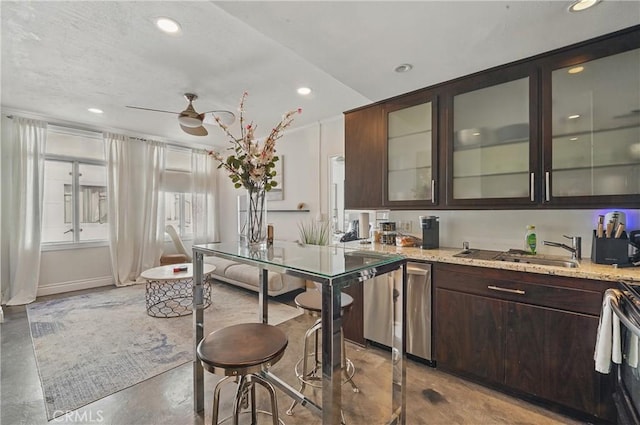 140 Linden Ave Unit 615, Long Beach, CA 90802 - kitchen with dark brown cabinetry, a sink, concrete flooring, recessed lighting, and glass insert cabinets