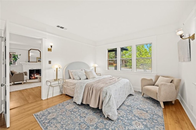 859 N Chester Ave, Pasadena, CA 91104 - bedroom featuring wood finished floors, a fireplace, and baseboards