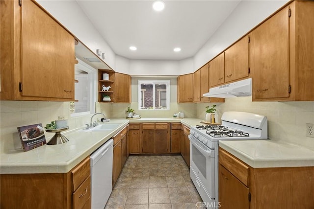 859 N Chester Ave, Pasadena, CA 91104 - kitchen featuring white appliances, under cabinet range hood, a sink, brown cabinetry, and tasteful backsplash
