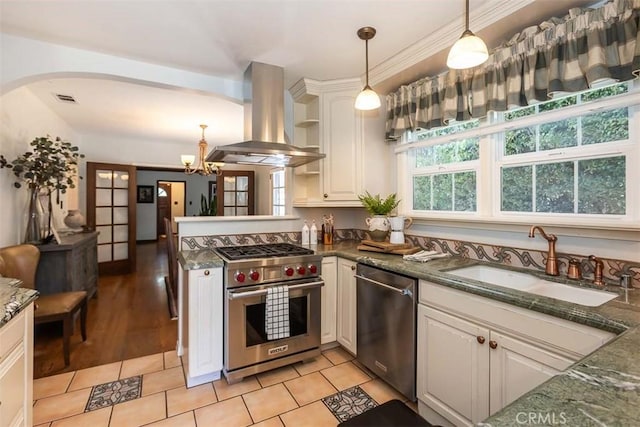 1443 Iris St, San Luis Obispo, CA 93401 - kitchen with appliances with stainless steel finishes, island exhaust hood, a sink, arched walkways, and hanging light fixtures