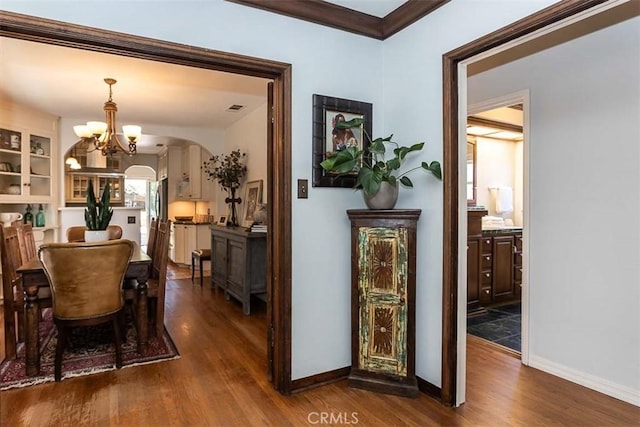1443 Iris St, San Luis Obispo, CA 93401 - dining space with dark wood-type flooring, a chandelier, arched walkways, and baseboards