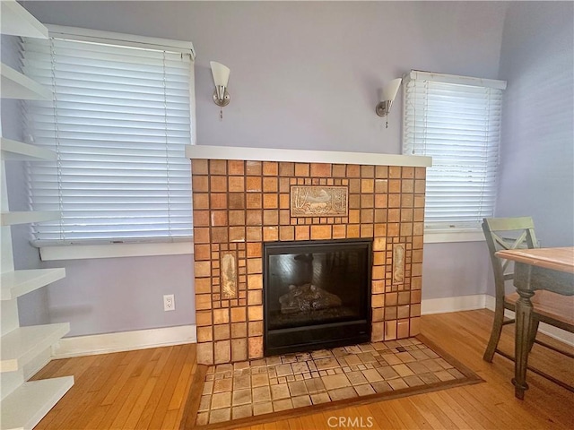 551 W Walnut Ave, Monrovia, CA 91016 - detailed view of wood finished floors, a brick fireplace, and baseboards