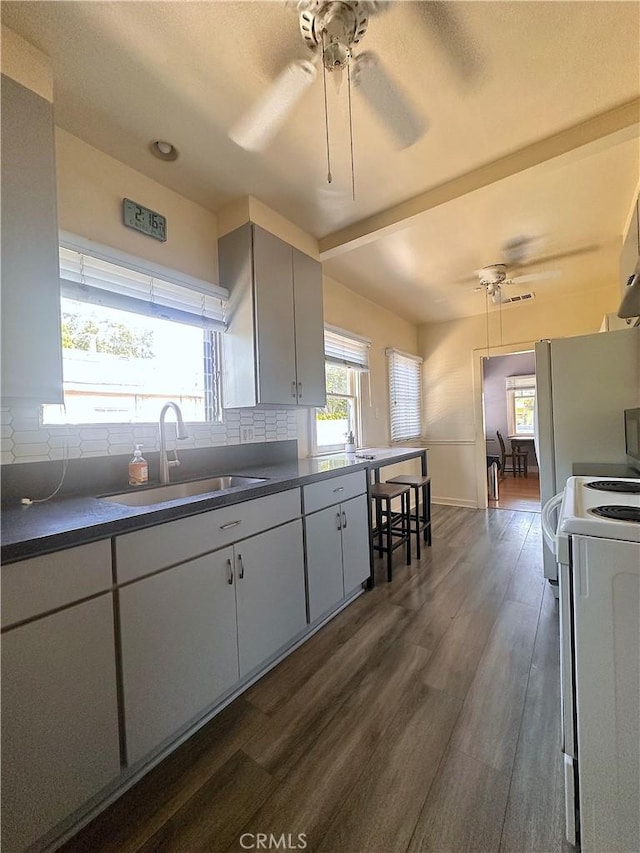 551 W Walnut Ave, Monrovia, CA 91016 - kitchen with a sink, electric range, a ceiling fan, dark countertops, and decorative backsplash