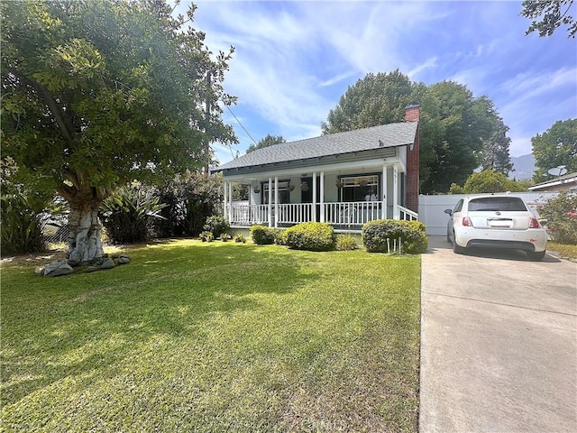 551 W Walnut Ave, Monrovia, CA 91016 - bungalow featuring covered porch, a front yard, a chimney, and a shingled roof