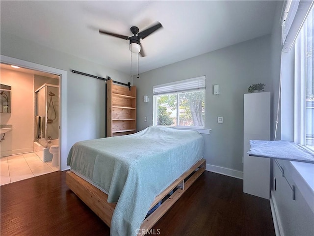 551 W Walnut Ave, Monrovia, CA 91016 - bedroom featuring wood finished floors, a barn door, baseboards, and a ceiling fan