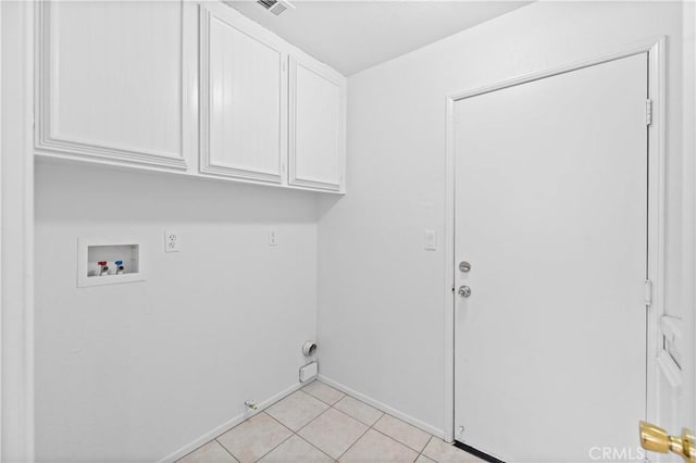 clothes washing area with hookup for a washing machine, cabinet space, light tile patterned floors, gas dryer hookup, and baseboards
