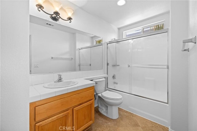 bathroom featuring vanity, toilet, combined bath / shower with glass door, and a chandelier