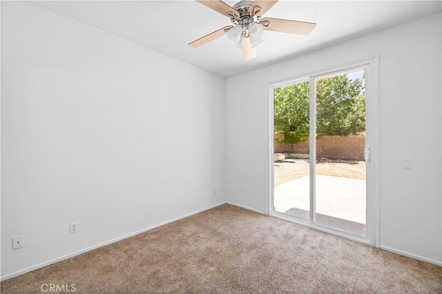 unfurnished room with carpet, a ceiling fan, and baseboards