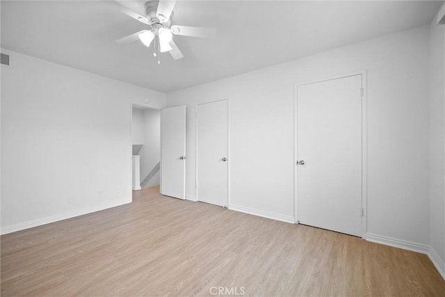 2709 S Baker St, Santa Ana, CA 92707 - unfurnished bedroom with wood finished floors, baseboards, and a ceiling fan