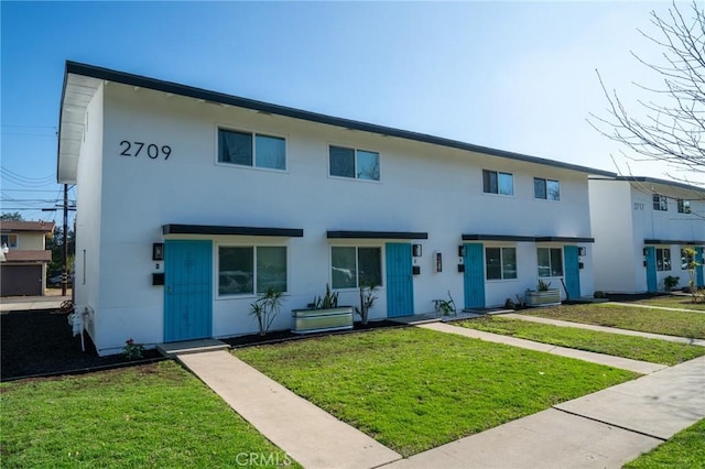 2709 S Baker St, Santa Ana, CA 92707 - townhome / multi-family property featuring a front lawn and stucco siding