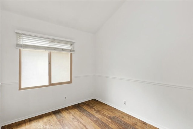 12528 Green Willow Dr, Garden Grove, CA 92845 - empty room with wood finished floors, baseboards, and lofted ceiling