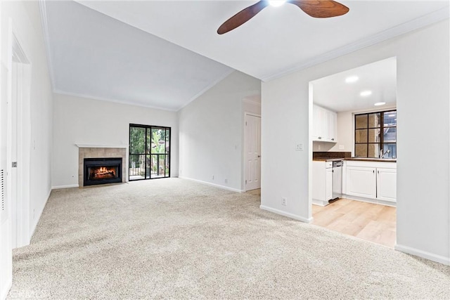 25641 Indian Hill Ln Unit C, Laguna Hills, CA 92653 - unfurnished living room with light carpet, ceiling fan, ornamental molding, baseboards, and a fireplace