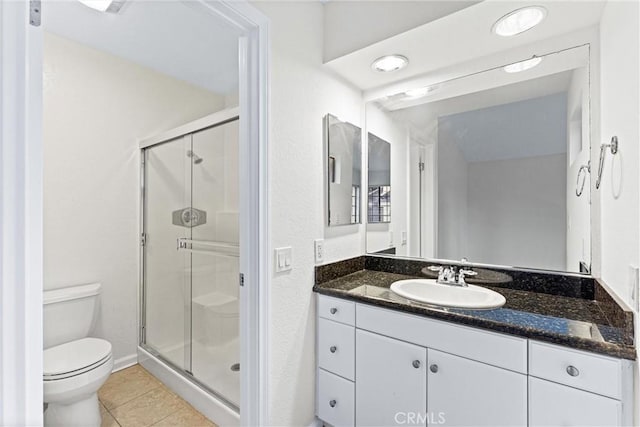 25641 Indian Hill Ln Unit C, Laguna Hills, CA 92653 - bathroom featuring a stall shower, vanity, toilet, and tile patterned flooring