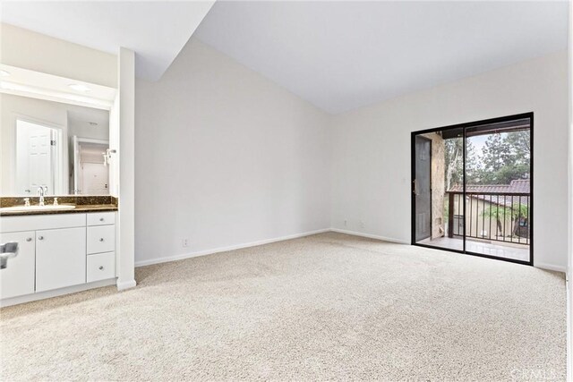 25641 Indian Hill Ln Unit C, Laguna Hills, CA 92653 - unfurnished bedroom featuring a sink, access to outside, light carpet, and baseboards
