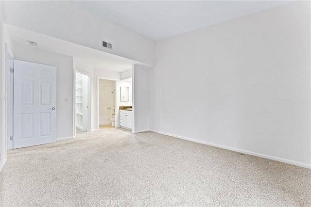 25641 Indian Hill Ln Unit C, Laguna Hills, CA 92653 - unfurnished bedroom with light colored carpet, baseboards, and connected bathroom
