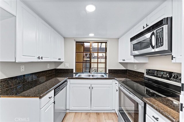 25641 Indian Hill Ln Unit C, Laguna Hills, CA 92653 - kitchen with appliances with stainless steel finishes, a sink, white cabinets, recessed lighting, and light wood-style floors