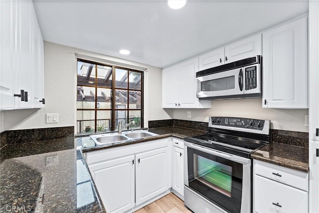 25641 Indian Hill Ln Unit C, Laguna Hills, CA 92653 - kitchen with appliances with stainless steel finishes, a sink, white cabinets, recessed lighting, and light wood-type flooring