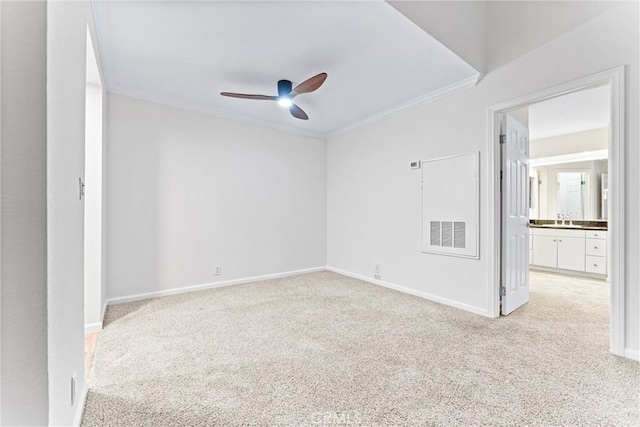 25641 Indian Hill Ln Unit C, Laguna Hills, CA 92653 - spare room with light colored carpet, ornamental molding, a ceiling fan, a sink, and baseboards