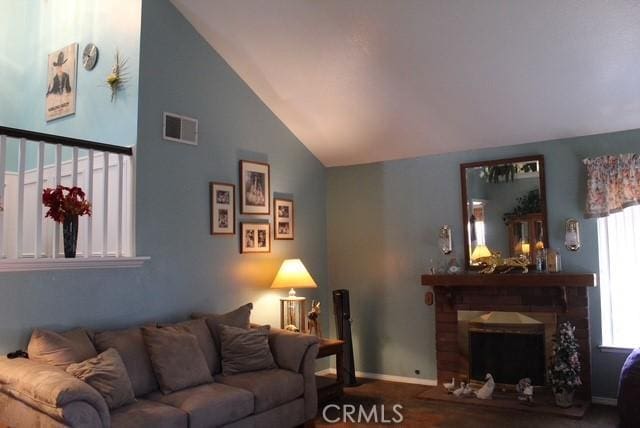 12601 Heartleaf St, Moreno Valley, CA 92553 - living room featuring lofted ceiling, a fireplace, and baseboards