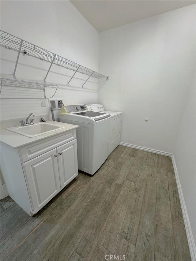 3397 Sequoia Ct, Perris, CA 92570 - washroom featuring wood finished floors, washing machine and clothes dryer, cabinet space, and baseboards