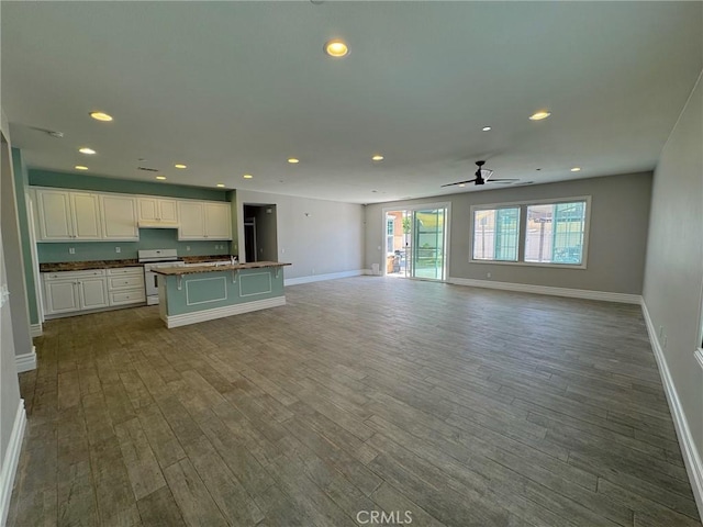 3397 Sequoia Ct, Perris, CA 92570 - unfurnished living room with baseboards, wood finished floors, recessed lighting, a ceiling fan, and a sink