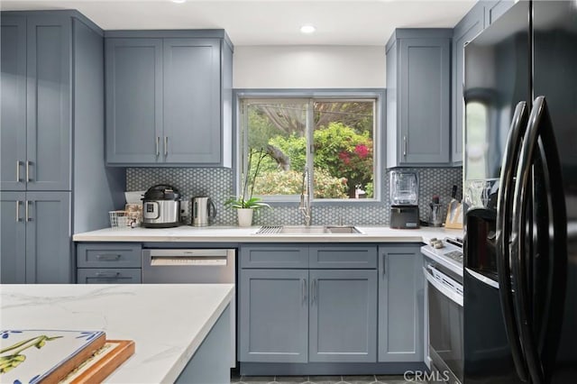 645 Griffith Way, Laguna Beach, CA 92651 - kitchen featuring appliances with stainless steel finishes, gray cabinetry, tasteful backsplash, a sink, and recessed lighting