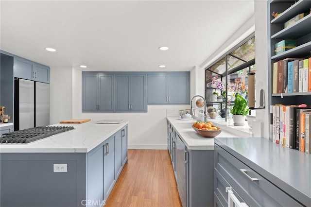 645 Griffith Way, Laguna Beach, CA 92651 - kitchen featuring stainless steel appliances, a sink, light wood-style flooring, recessed lighting, and light stone countertops
