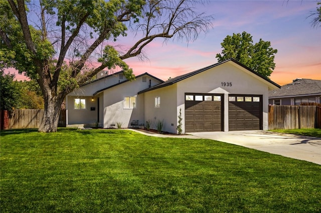 1935 N Mayfair Dr, Hanford, CA 93230 - view of front of home featuring stucco siding, an attached garage, and driveway