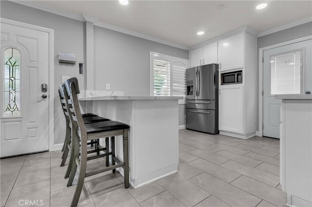 6038 Coke Ave, Long Beach, CA 90805 - kitchen with stainless steel fridge with ice dispenser, built in microwave, crown molding, white cabinetry, and recessed lighting