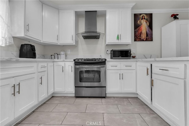 6038 Coke Ave, Long Beach, CA 90805 - kitchen with appliances with stainless steel finishes, wall chimney range hood, light countertops, white cabinets, and light tile patterned floors
