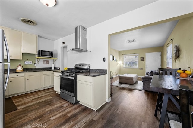 1980 N Sierra Way, San Bernardino, CA 92405 - kitchen featuring stainless steel appliances, wall chimney exhaust hood, dark wood-style floors, open floor plan, and cream cabinets