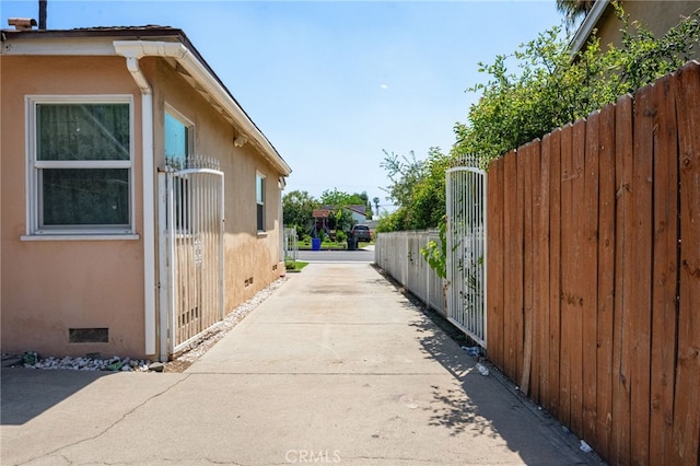 1980 N Sierra Way, San Bernardino, CA 92405 - view of side of property featuring stucco siding, fence, and crawl space