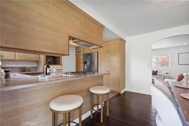 6028 Hart Ave, Temple City, CA 91780 - kitchen with appliances with stainless steel finishes, light brown cabinets, arched walkways, and light stone counters