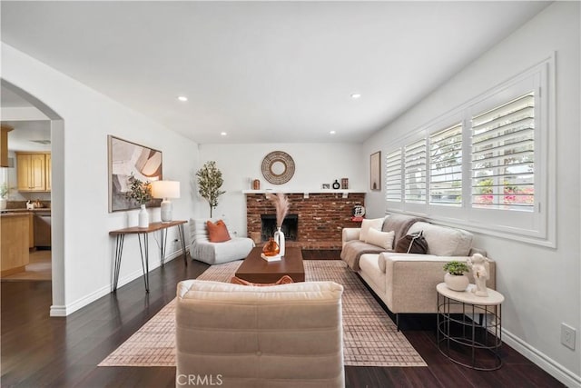 6028 Hart Ave, Temple City, CA 91780 - living area with dark wood-style flooring, arched walkways, baseboards, recessed lighting, and a fireplace