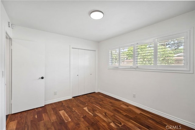 6028 Hart Ave, Temple City, CA 91780 - unfurnished bedroom with dark wood-style floors, baseboards, and a closet