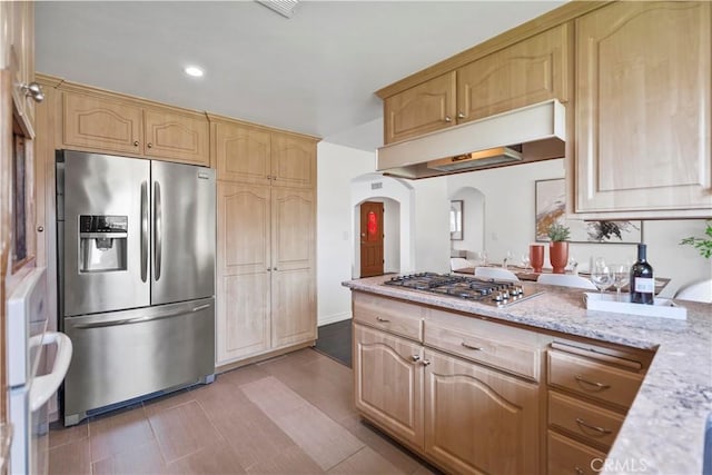 6028 Hart Ave, Temple City, CA 91780 - kitchen featuring appliances with stainless steel finishes, under cabinet range hood, arched walkways, light stone countertops, and recessed lighting